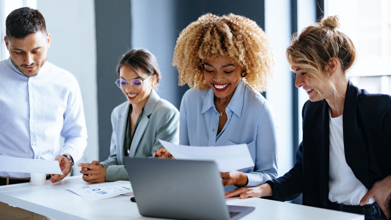 Smiling Businesspeople Working Together On A New Project